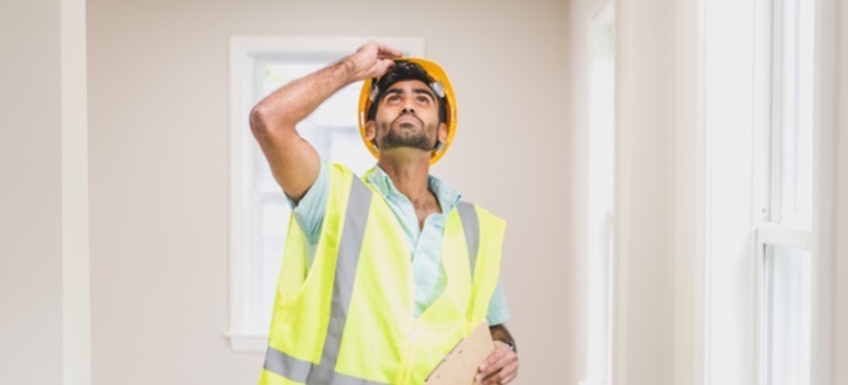Structurally Speaking: Senate Bill 4-D 3 A home inspector looking up inspecting the interior of a house