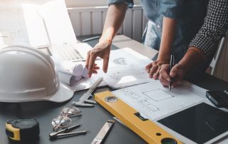 Permitting Blueprint Plans being reviewed in the office